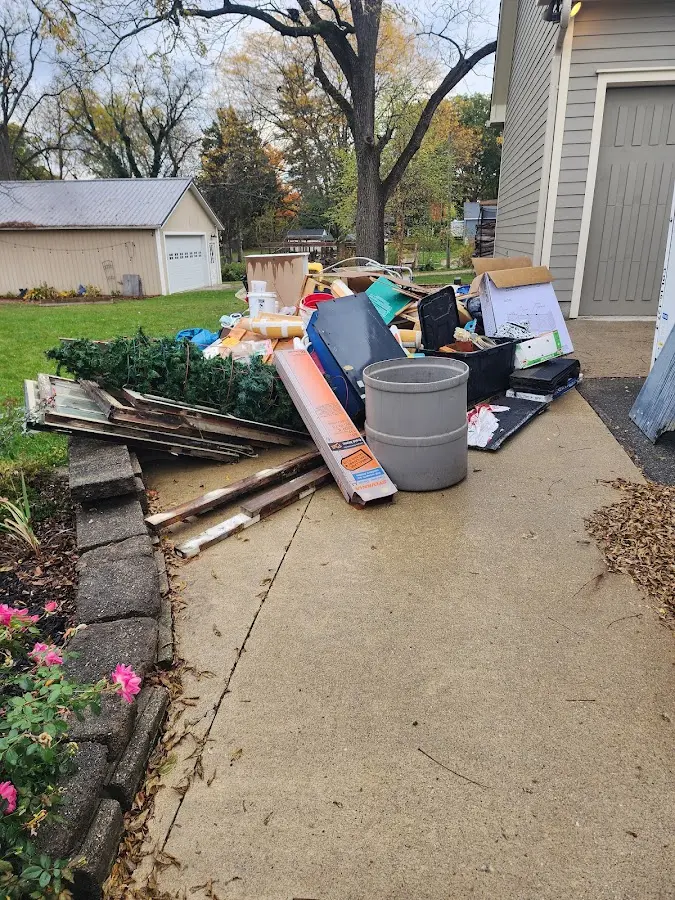 Dumpster being loaded with debris for Estate Cleanout Dumpster Rental in Gorham